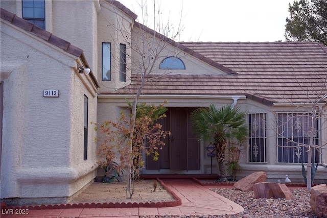 property entrance with stucco siding