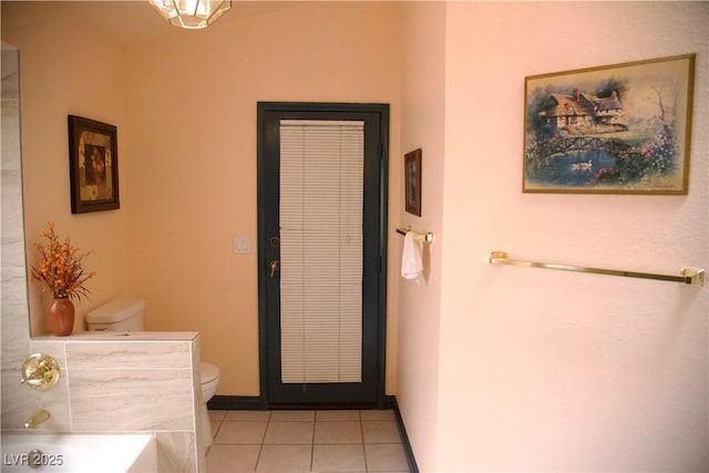 full bath featuring tile patterned flooring, toilet, and baseboards