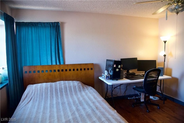 bedroom with ceiling fan, baseboards, a textured ceiling, and wood finished floors