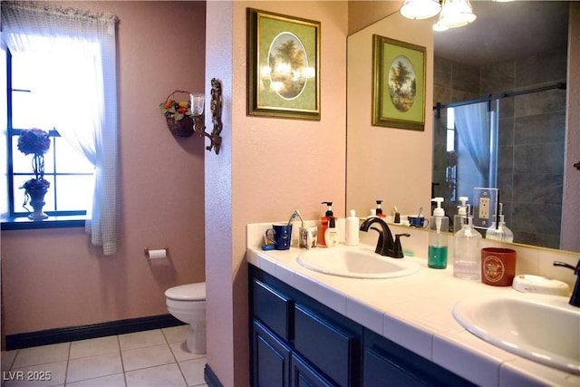 bathroom with plenty of natural light, a stall shower, and a sink