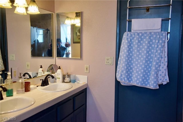 bathroom with a sink and double vanity