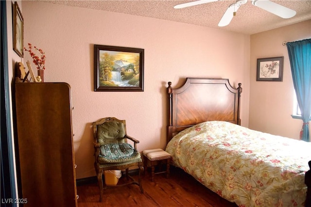 bedroom with ceiling fan, wood finished floors, and a textured ceiling