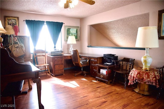 office area with a textured ceiling, a ceiling fan, and wood finished floors