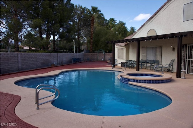 view of pool with a pool with connected hot tub, a patio area, and a fenced backyard