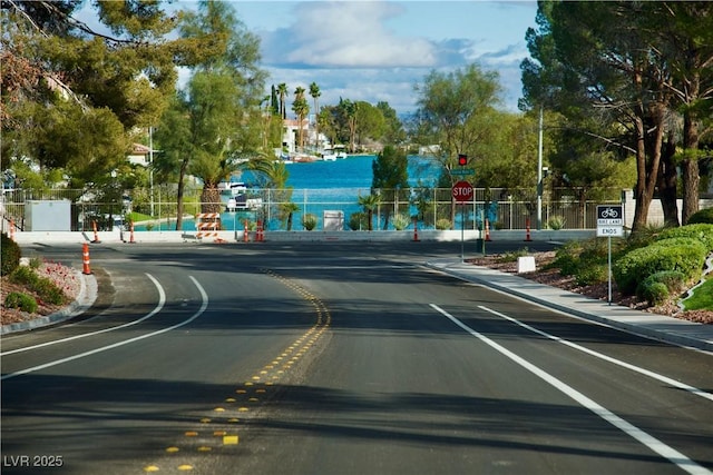 view of road with traffic signs and curbs