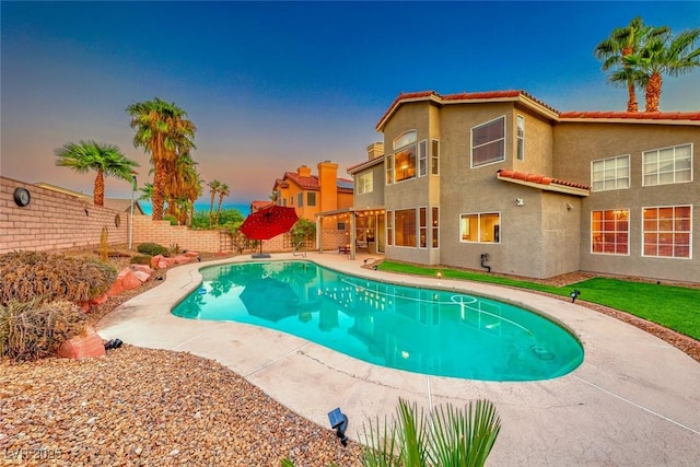 view of swimming pool featuring a patio area, a fenced backyard, and a fenced in pool