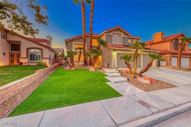 mediterranean / spanish-style house featuring stucco siding, concrete driveway, a front yard, and a tile roof