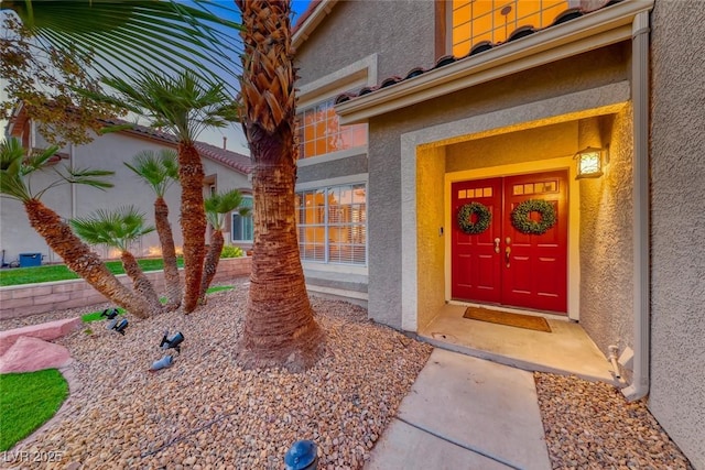 doorway to property with stucco siding