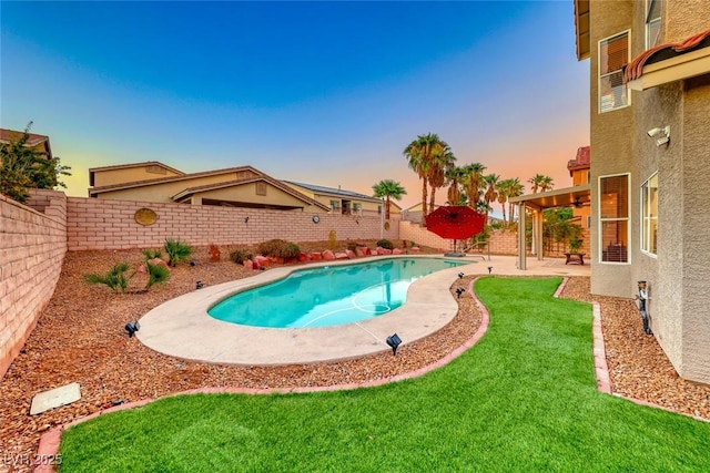 pool at dusk with a patio, a yard, a fenced backyard, and a fenced in pool