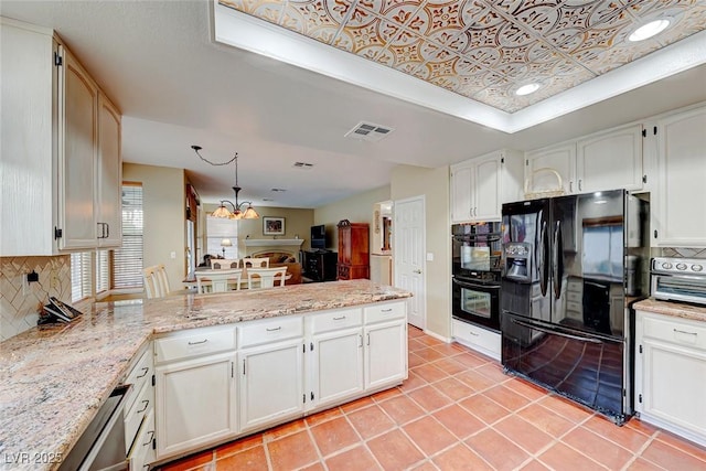 kitchen featuring visible vents, black appliances, an ornate ceiling, tasteful backsplash, and a peninsula