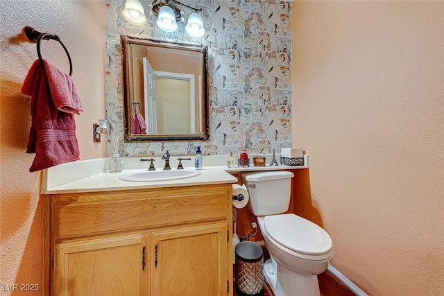 half bath featuring toilet and vanity