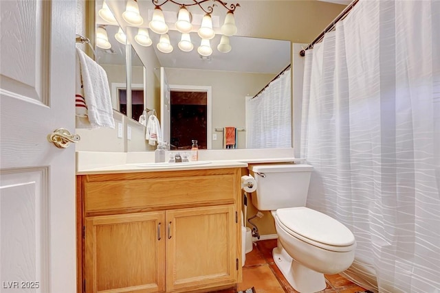 full bathroom with toilet, a chandelier, and vanity