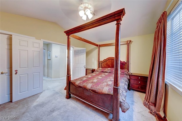 bedroom with carpet floors, ceiling fan, and vaulted ceiling