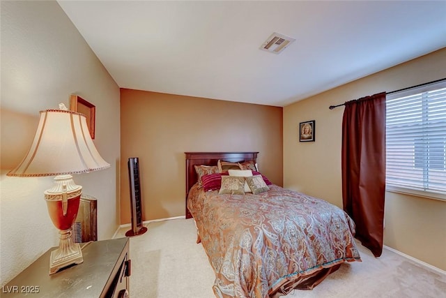 carpeted bedroom with baseboards and visible vents