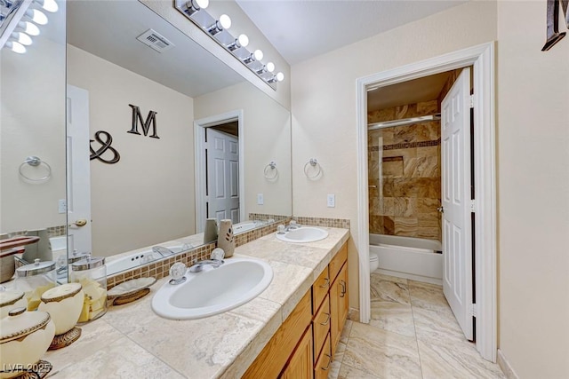 bathroom with double vanity, visible vents, marble finish floor, and a sink