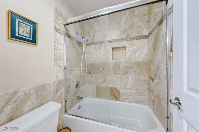 bathroom featuring toilet and enclosed tub / shower combo