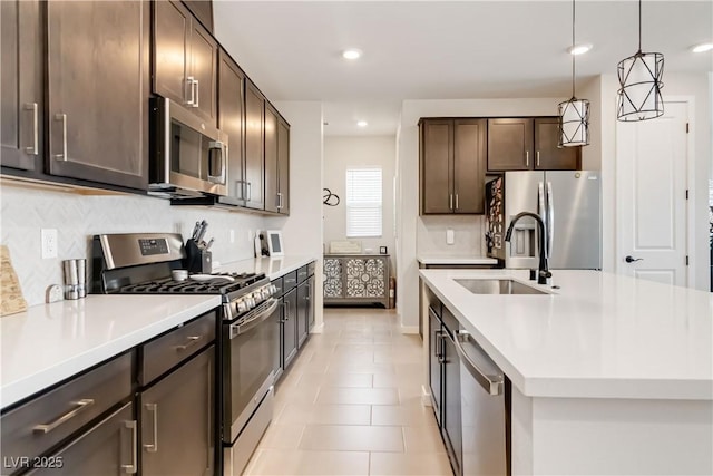 kitchen with a sink, light countertops, dark brown cabinets, and stainless steel appliances