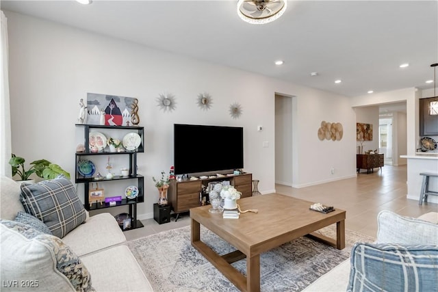 living room featuring light tile patterned floors, recessed lighting, and baseboards