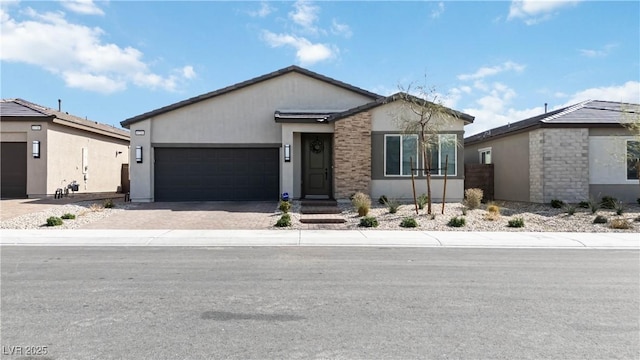 view of front facade featuring stucco siding, driveway, and an attached garage