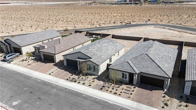 drone / aerial view featuring a residential view and view of desert