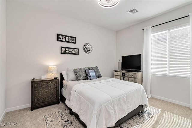 bedroom with light carpet, visible vents, and baseboards