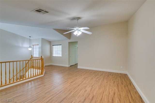 spare room featuring visible vents, baseboards, and light wood-style flooring