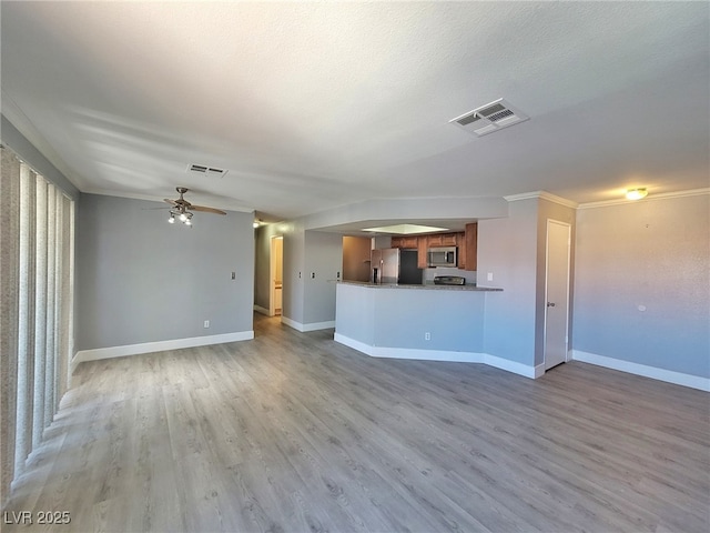 unfurnished living room with visible vents, a ceiling fan, light wood-type flooring, and baseboards