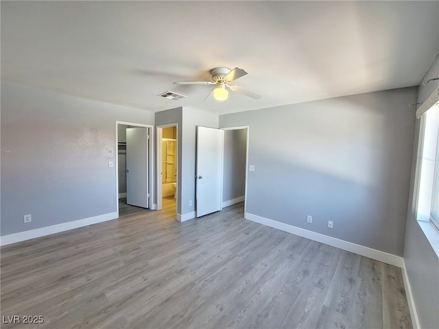 unfurnished bedroom with visible vents, baseboards, a ceiling fan, and light wood finished floors