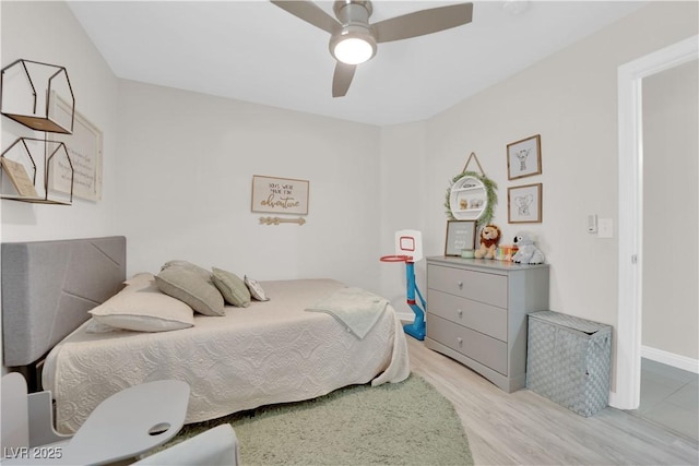 bedroom with light wood finished floors and a ceiling fan