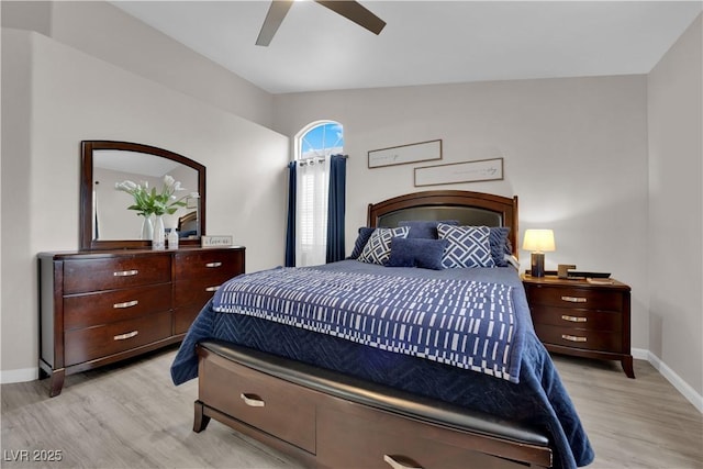 bedroom featuring a ceiling fan, lofted ceiling, baseboards, and light wood-type flooring