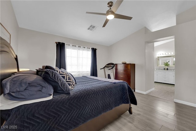 bedroom featuring visible vents, light wood-style floors, baseboards, ceiling fan, and vaulted ceiling