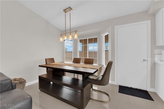 dining area with light tile patterned floors and baseboards