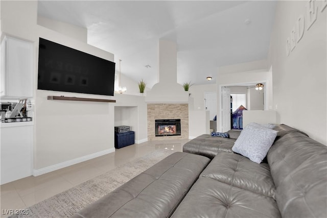 tiled living room with a tiled fireplace, high vaulted ceiling, baseboards, and a ceiling fan