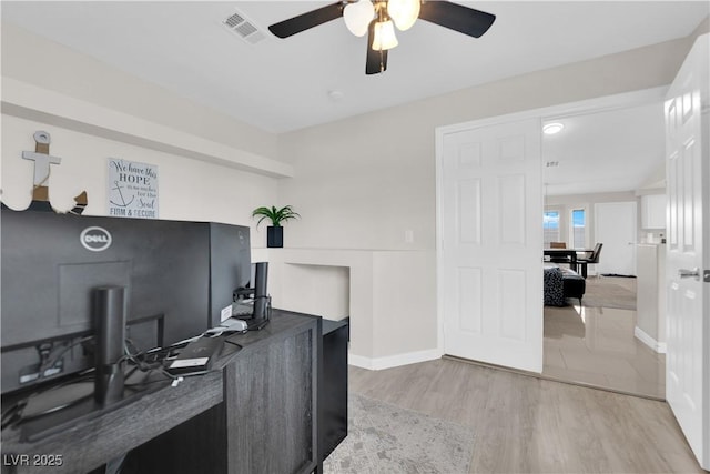 office area featuring visible vents, baseboards, wood finished floors, and a ceiling fan