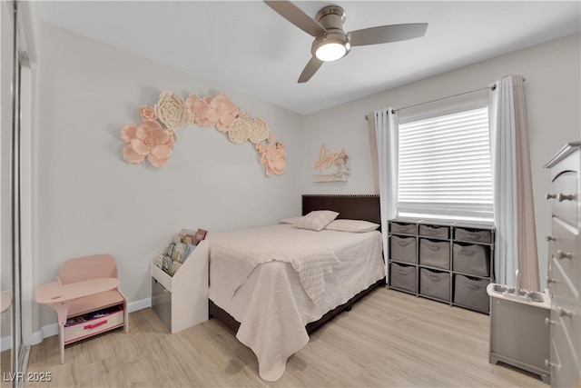 bedroom featuring a ceiling fan, wood finished floors, and baseboards