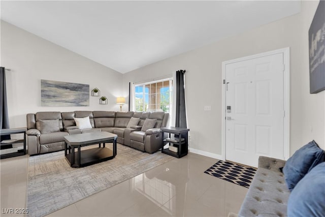 tiled living room featuring baseboards and vaulted ceiling