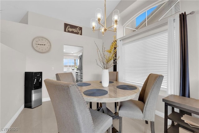 dining space with baseboards and a chandelier