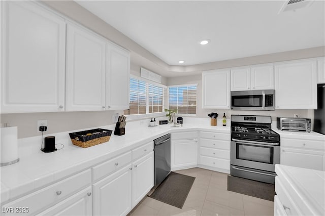 kitchen featuring white cabinetry and stainless steel appliances