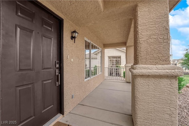 entrance to property featuring stucco siding