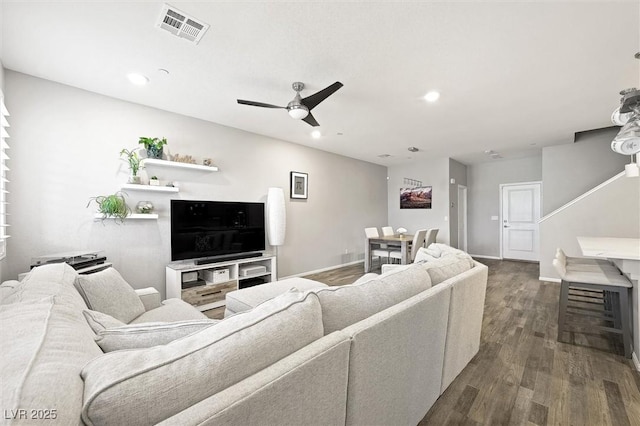 living area featuring visible vents, baseboards, recessed lighting, a ceiling fan, and dark wood-style flooring