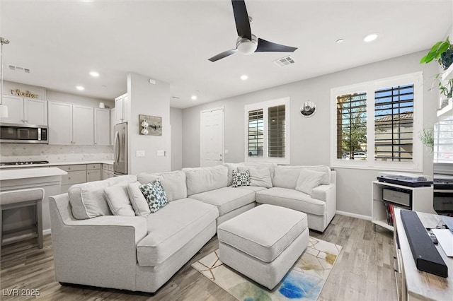 living room featuring recessed lighting, visible vents, ceiling fan, and light wood finished floors