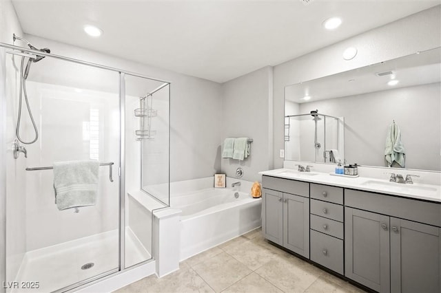 bathroom with double vanity, a stall shower, a bath, and a sink