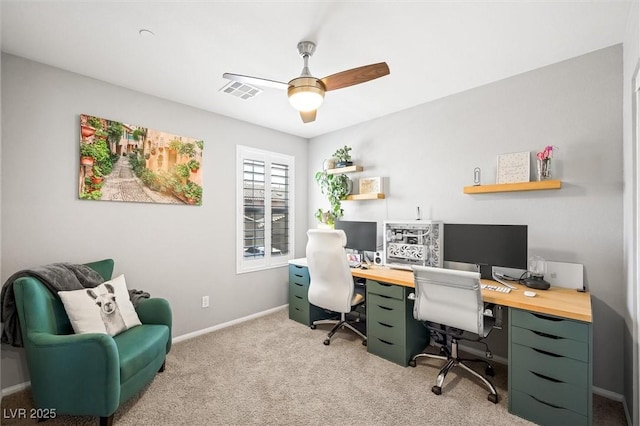 office featuring baseboards, a ceiling fan, visible vents, and light carpet