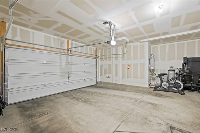 garage with water heater and a garage door opener