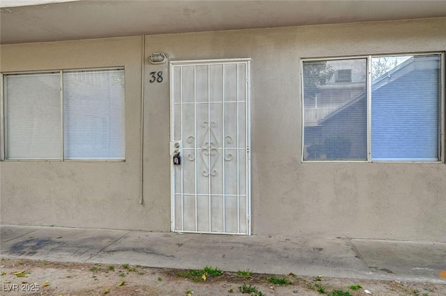 entrance to property with stucco siding