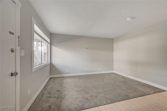 spare room featuring wood finished floors and baseboards