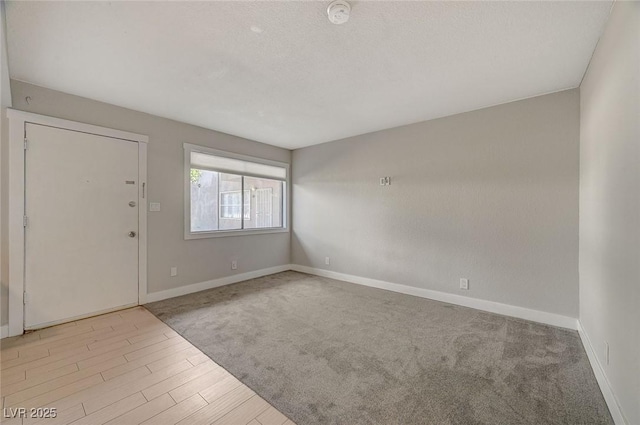 unfurnished room featuring baseboards and wood finished floors