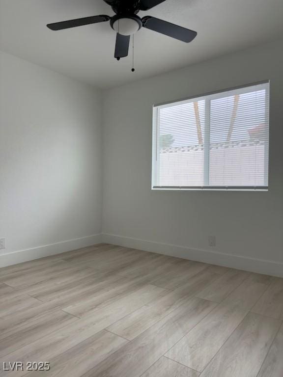 unfurnished room with a ceiling fan, baseboards, and light wood finished floors