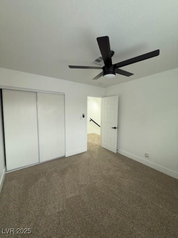 unfurnished bedroom featuring visible vents, a ceiling fan, a closet, carpet, and baseboards