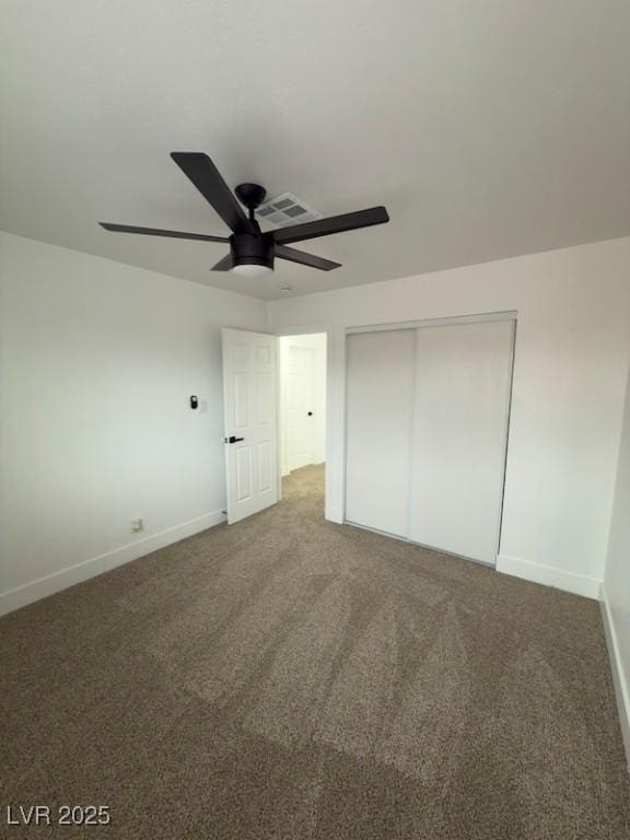 unfurnished bedroom featuring visible vents, a closet, carpet flooring, baseboards, and ceiling fan